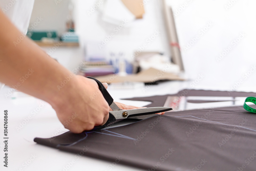 Close up portrait of fashion designer working in sewing studio. Close up portrait of fashion designer working in sewing studio.