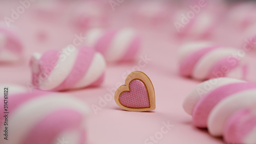 Heart of marshmellows. Lots of pink marshmallows on a pink background and hearts between it. Valentine's day.