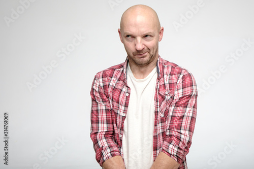 Bald man is guilty. He looks away from bashfulness and embarrassment. Copy space.