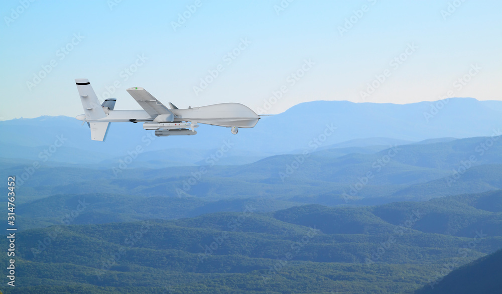 unmanned RC military drone flies over low mountains in mist unmanned RC military drone flies over low mountains in mist