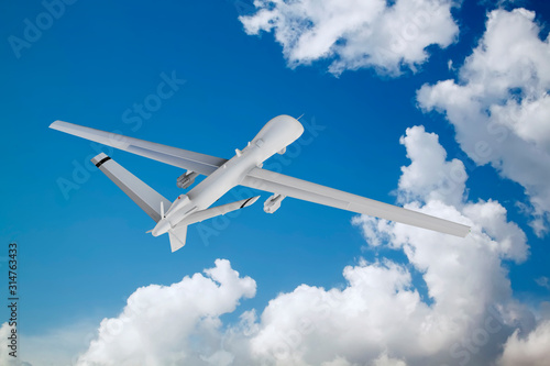 military RC military drone flies flies against backdrop of beautiful clouds on blue sky background.