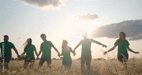 Group of boys and girls walking together hand in hand. The concept of peace, friendship, happiness, success and achievement