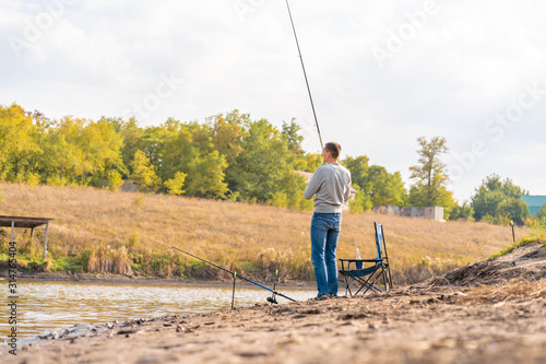 Man relaxing and fishing by lakeside a