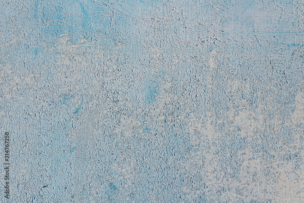 Obraz premium Soft blue abstract background with cracked paint.
