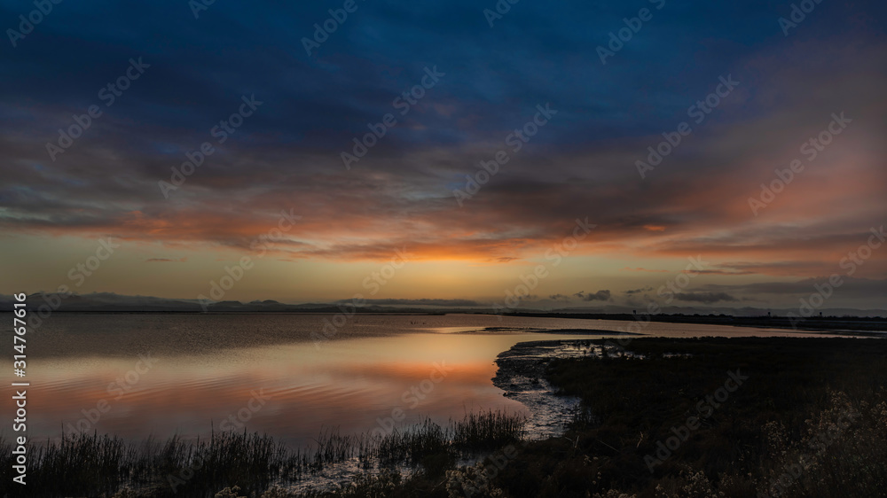 Sunrise into the clouds over the marsh wetlands off highway 37 in Vallejo Ca. Sunrise into the clouds over the marsh wetlands off highway 37 in Vallejo Ca.