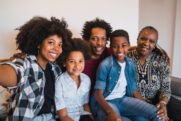 Multigenerational family taking selfie at home.
