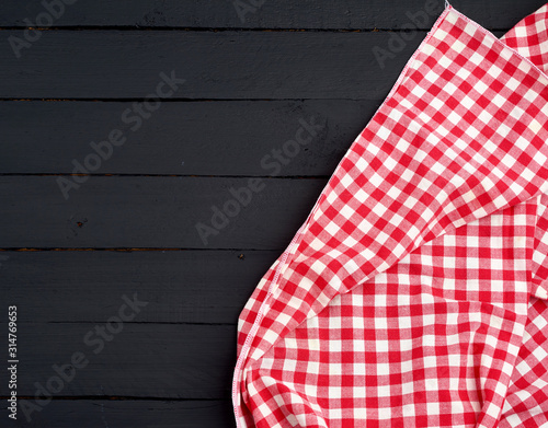 white red checkered kitchen towel on a dark blue wooden background