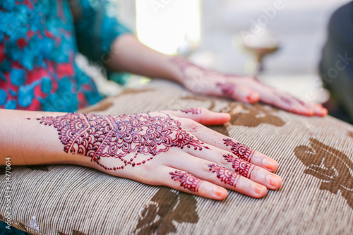 Very beautiful and unique henna paintings are on both hands of the bride. photo