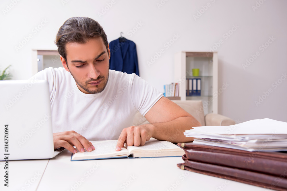 Young male student preparing for exams at home Young male student preparing for exams at home