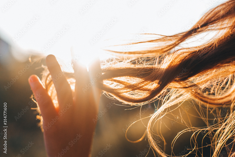Woman touches the lock of hair. Selective focus - obrazy, fototapety, plakaty 