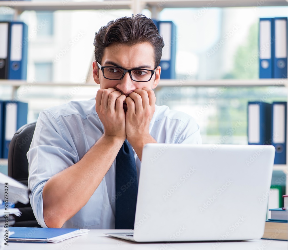 Businessman with excessive work paperwork working in office Businessman with excessive work paperwork working in office