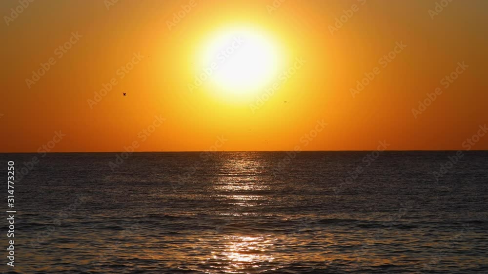 Sun rising over the horizon. Dramatic sunrise over sea waves Sun rising over the horizon. Dramatic sunrise over sea waves