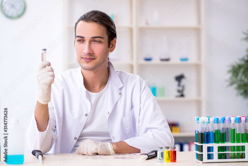 Young male chemist working in the lab Young male chemist working in the lab