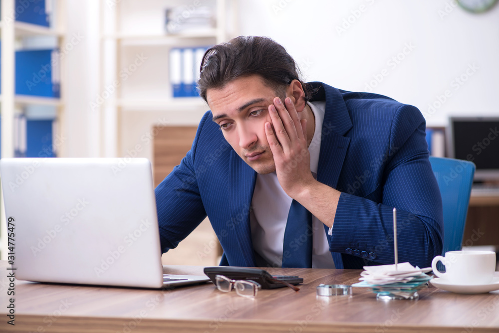 Young male businessman working in the office Young male businessman working in the office