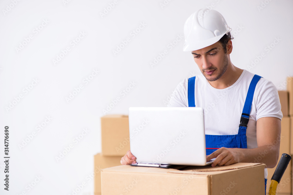 Young male professional mover doing home relocation Young male professional mover doing home relocation