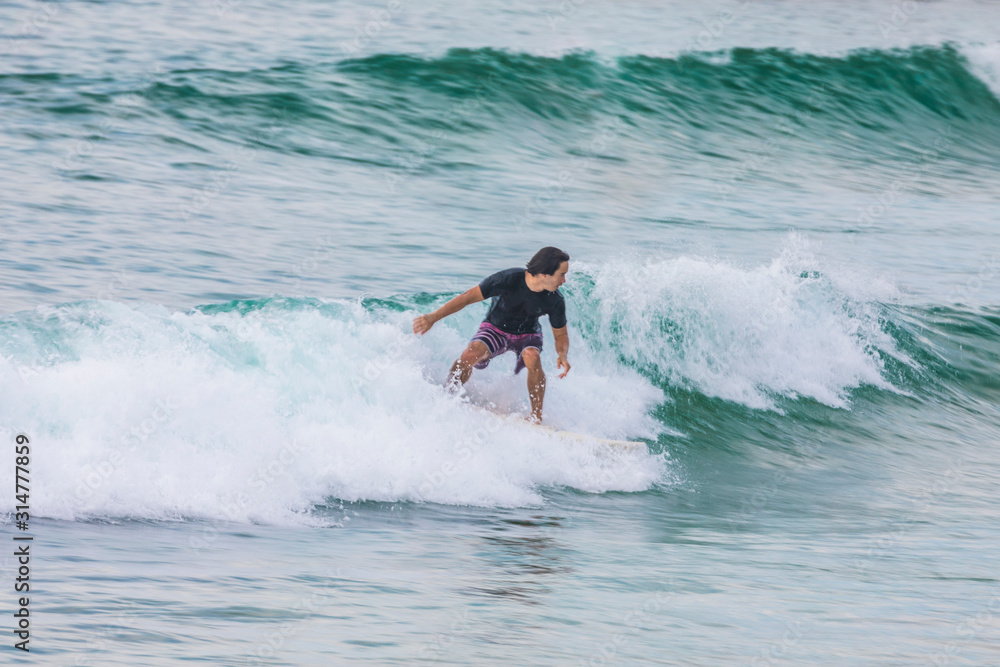 Australian Surfer riding a wave in Sydney Australian Surfer riding a wave in Sydney