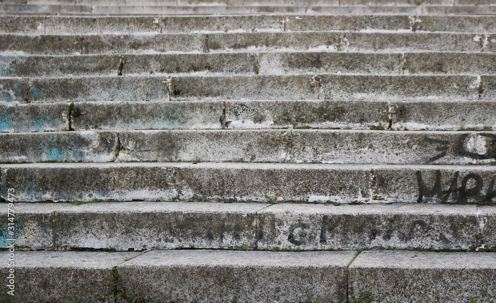 steps of a concrete staircase on the street - vintage dirty texture with graffiti steps of a concrete staircase on the street - vintage dirty texture with graffiti