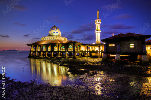 Al-Hussain Mosque by the sea with sunset blue hour views located in Perlis Malaysia.