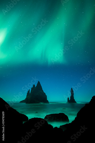 Aurora Borealis (Northern Lights) above Vik rock formation, Iceland