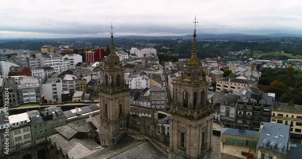 Ascending aerial pan of cathedral overlooking hills in City of Lugo, Spain. Ascending aerial pan of cathedral overlooking hills in City of Lugo, Spain.