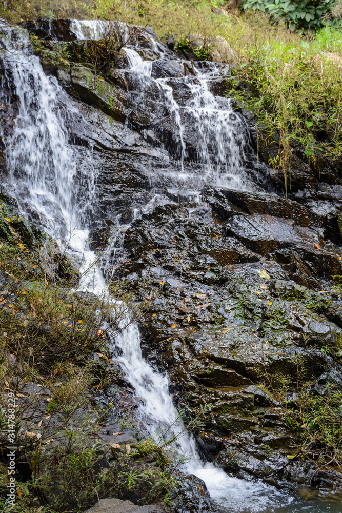 The beautiful waterfalls, rapids and mountain streams in the tropical forest in Yanoda Park, Sanya city. Hainan, China. The beautiful waterfalls, rapids and mountain streams in the tropical forest in Yanoda Park, Sanya city. Hainan, China.