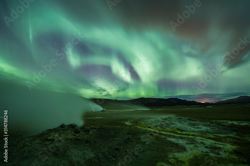 Aurora Borealis (Northern Lights) above geothermal volcanic vents in Hveravellir