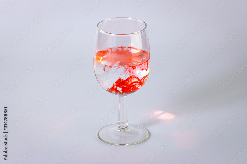 Wine Glass of water with flowing red swill Wine Glass of water with flowing red swill
