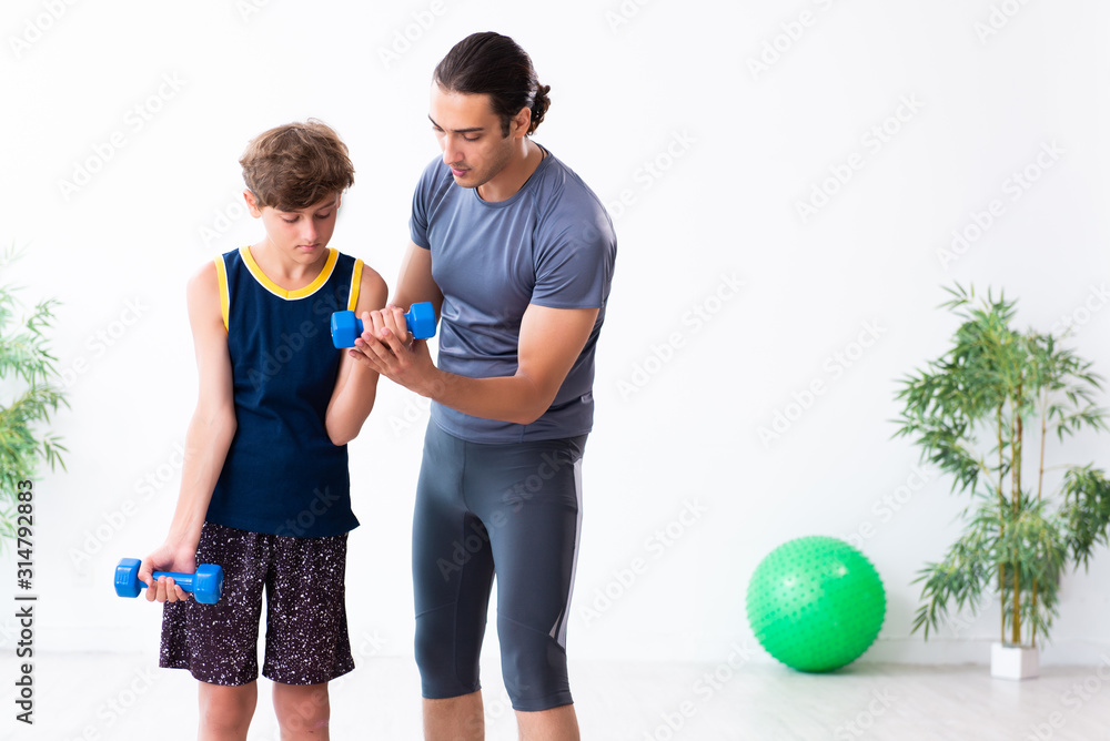Young father and his son doing exercises Young father and his son doing exercises