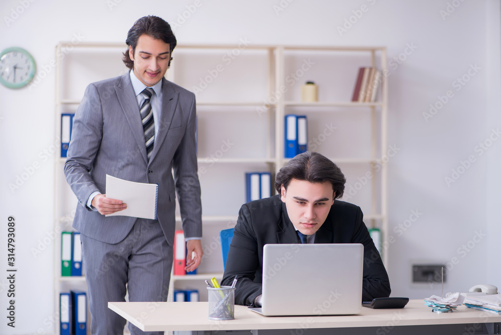 Two young employees working in the office Two young employees working in the office