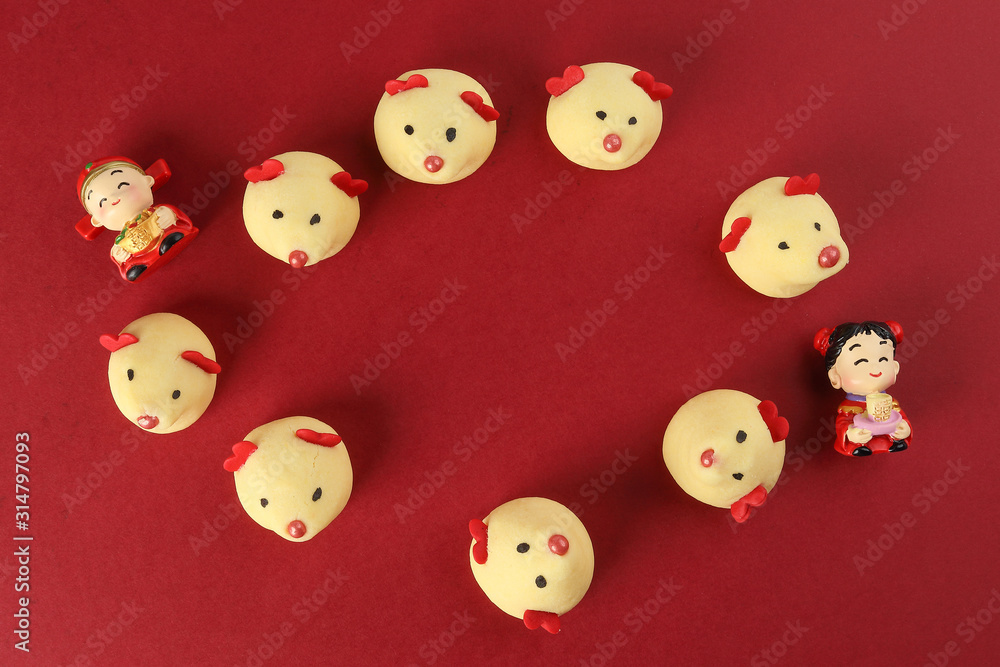 Chinese New Year rat mouse shaped cookie boy girl doll on red background Chinese New Year rat mouse shaped cookie boy girl doll on red background