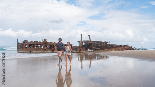 Couple walking on the Beach at SS Maheno Wreck on Fraser Island