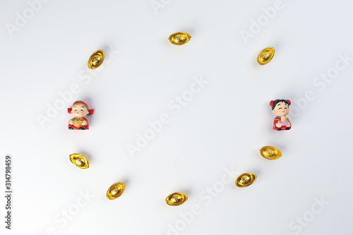 Chinese boy girl doll figurine money syce ingot gold on white background copy space
