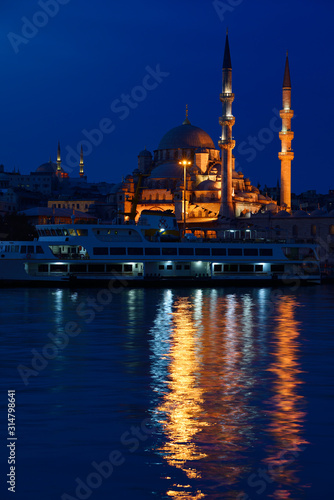 The New Mosque with Nuruosmaniye at twilight early morning with lights reflected in the Golden Horn Istanbul