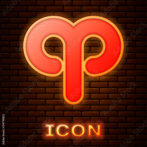 Glowing neon Aries zodiac sign icon isolated on brick wall background. Astrological horoscope collection. Vector Illustration