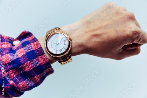 looking at luxury watch on hand check the time at workplace.concept for managing time organization working,punctuality,appointment.fashionable wearing stylish