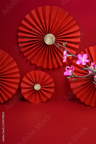 Lucky Chinese new year red background decoration with cherry blossom flower and paper fan