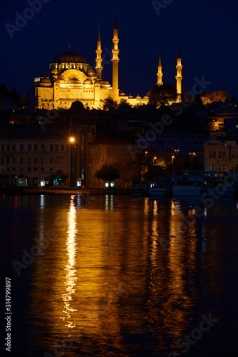 Lights of Suleymaniye Mosque largest in Istanbul reflected before dawn in waters of the Golden Horn