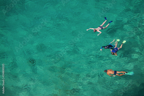 three people swimming in the sea © Carlos Grillo