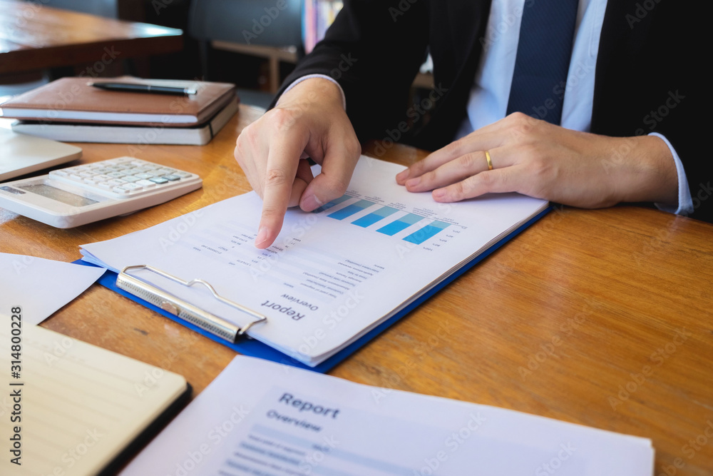 Sitting and working, consulting and suggesting work, checking work reports with a calculator in a business office. Sitting and working, consulting and suggesting work, checking work reports with a calculator in a business office.
