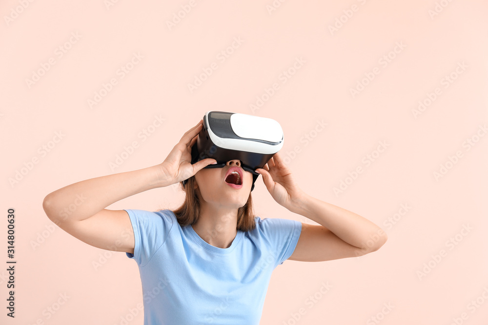 Young woman with virtual reality glasses on color background Young woman with virtual reality glasses on color background