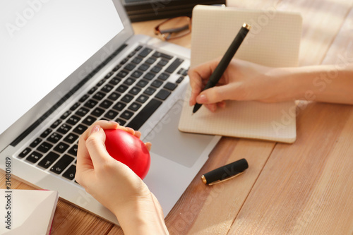 Woman squeezing stress ball...