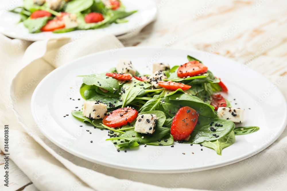 Plate with tasty salad on table Plate with tasty salad on table