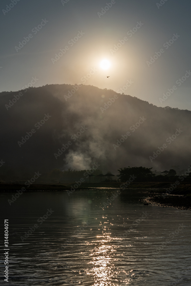 Mountain landscape with flare of the sun rise.