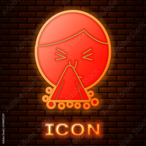 Glowing neon Man holding handkerchief or napkin to his runny nose icon isolated on brick wall background. Coryza desease symptoms. Vector Illustration