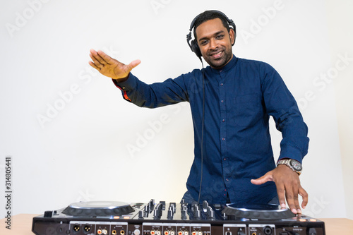 Male DJ playing music on white background