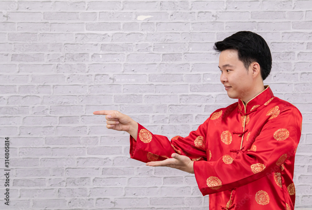 Selective focus smart happy Asian, Chinese man holding many red envelopes, money or banknotes inside in Chinese New Year traditional Lunar festival, man excited something, copy space for advertisement Selective focus smart happy Asian, Chinese man holding many red envelopes, money or banknotes inside in Chinese New Year traditional Lunar festival, man excited something, copy space for advertisement