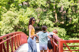 Portrait of a woman standing on a bridge with her children.