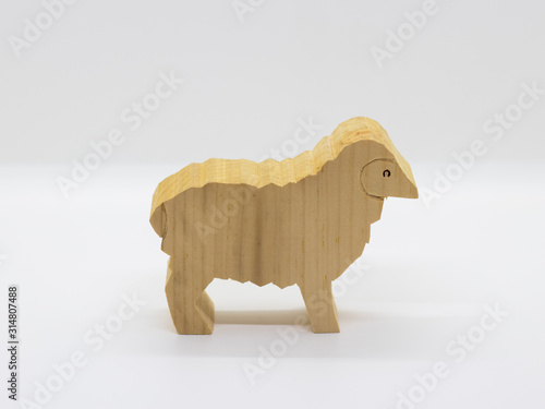 Handcrafted wooden sheep isolated on white background