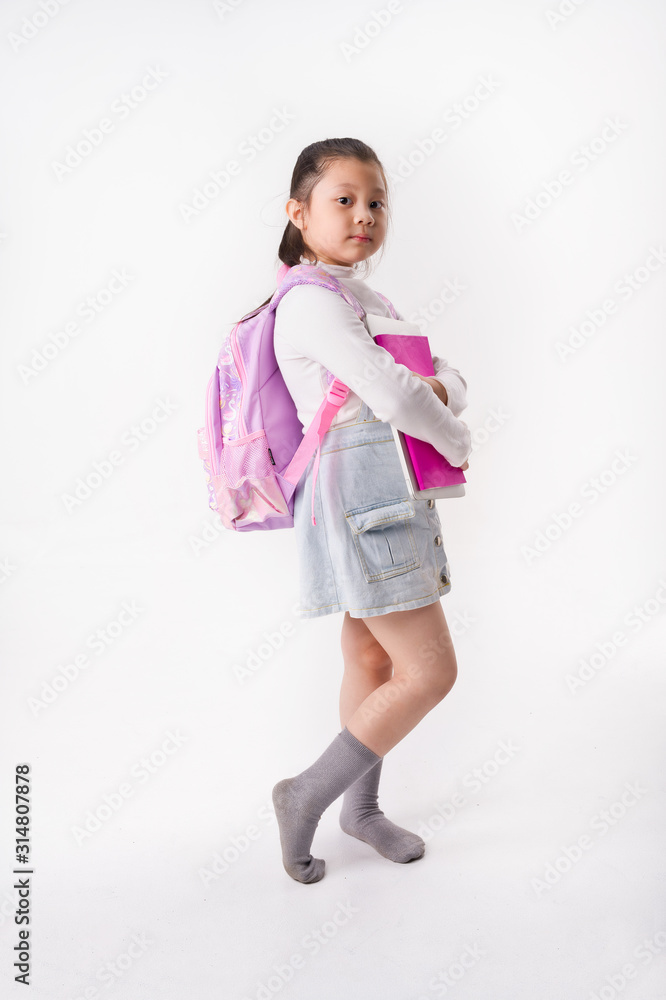 Asian Little girl hold study book and laptop on white background, Education Concept Asian Little girl hold study book and laptop on white background, Education Concept