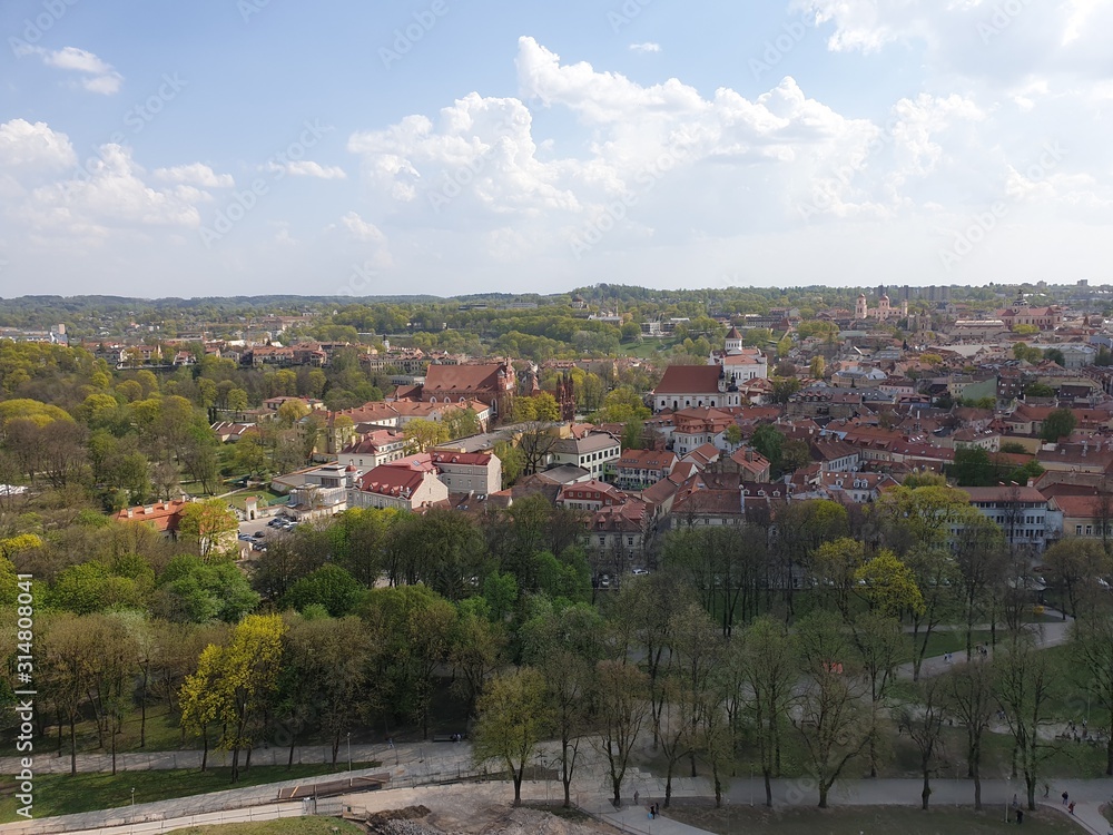 Panoramic view of the colorful forest and urban roofs of houses against a blue sky. Vilnius. Lithuania